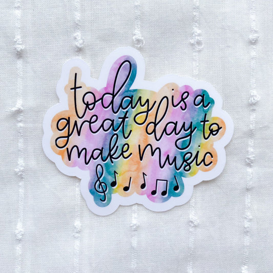 Colorful sticker with 'today is a great day to make music' text on a textured white background
