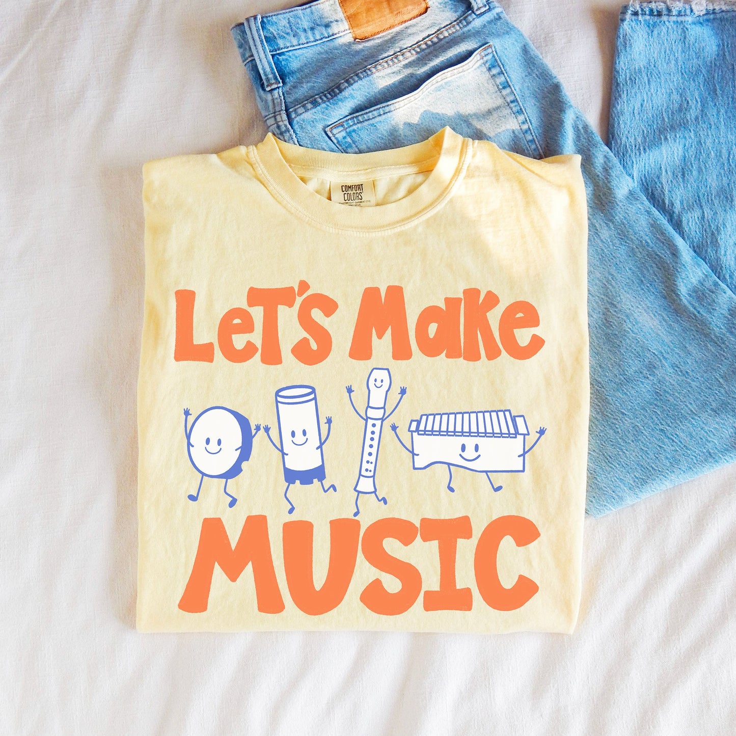Let's Make Music Shirt. A yellow shirt with elementary music instruments on it.