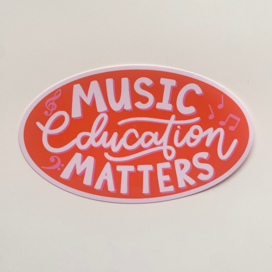 Music Education Matters Bumper Sticker. A red bumper sticker in the shape of an oval that says Music Education Matters in White and Pink text.