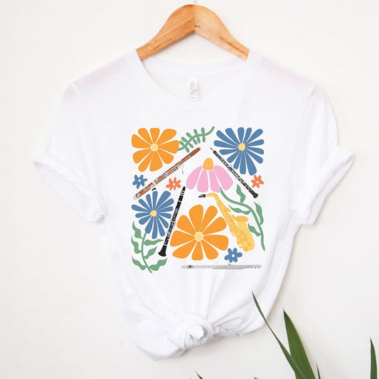 white shirt with woodwind instruments and flowers