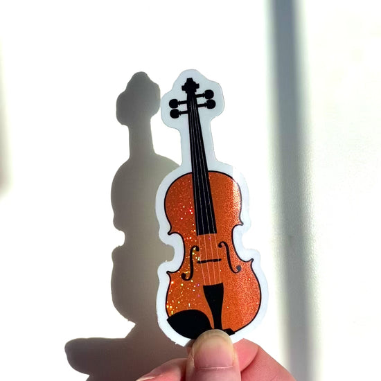 a video of a violin sticker or viola sticker in the sunlight