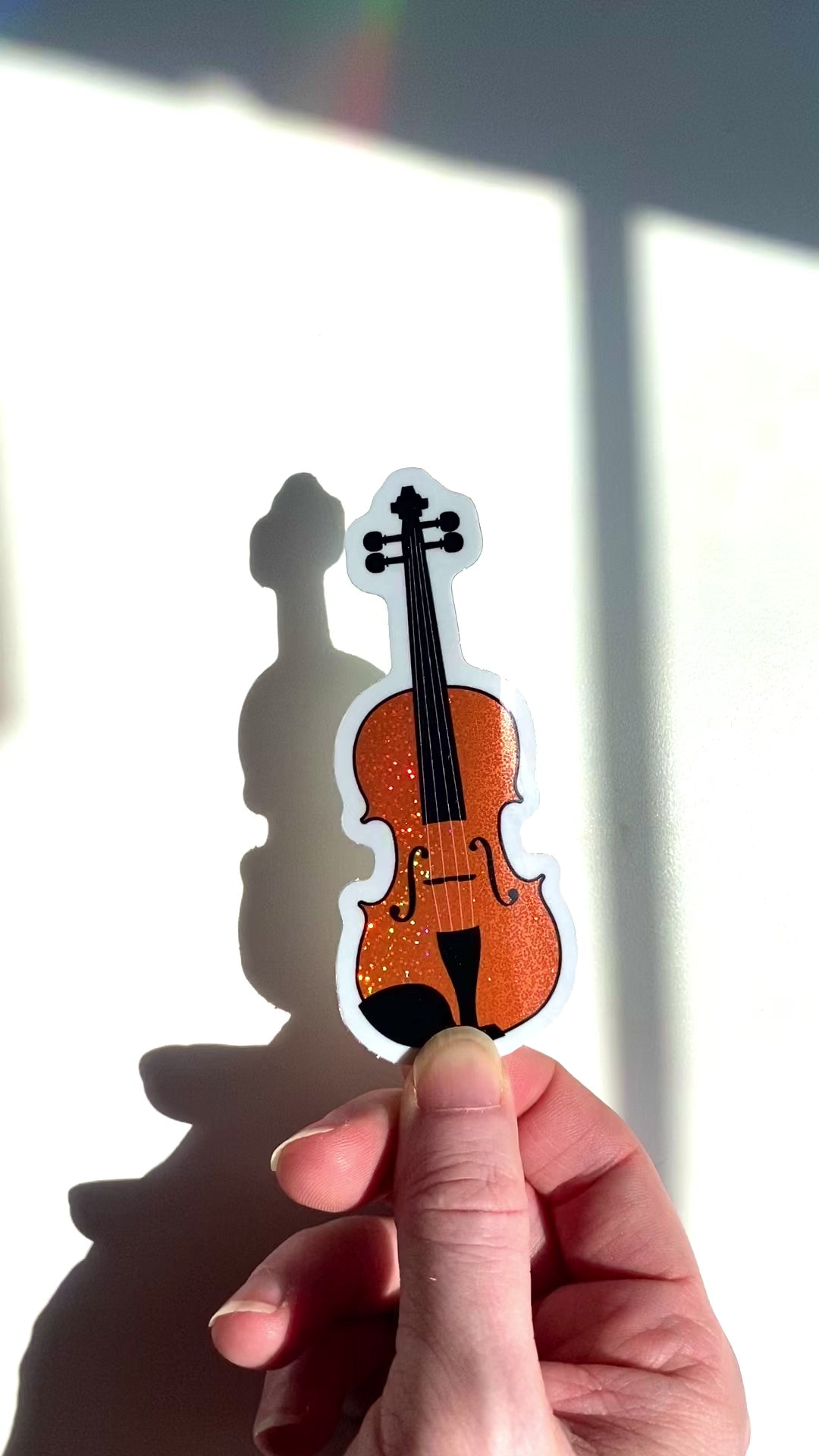 a video of a violin sticker or viola sticker in the sunlight